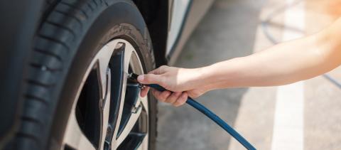 Person filling up their tire